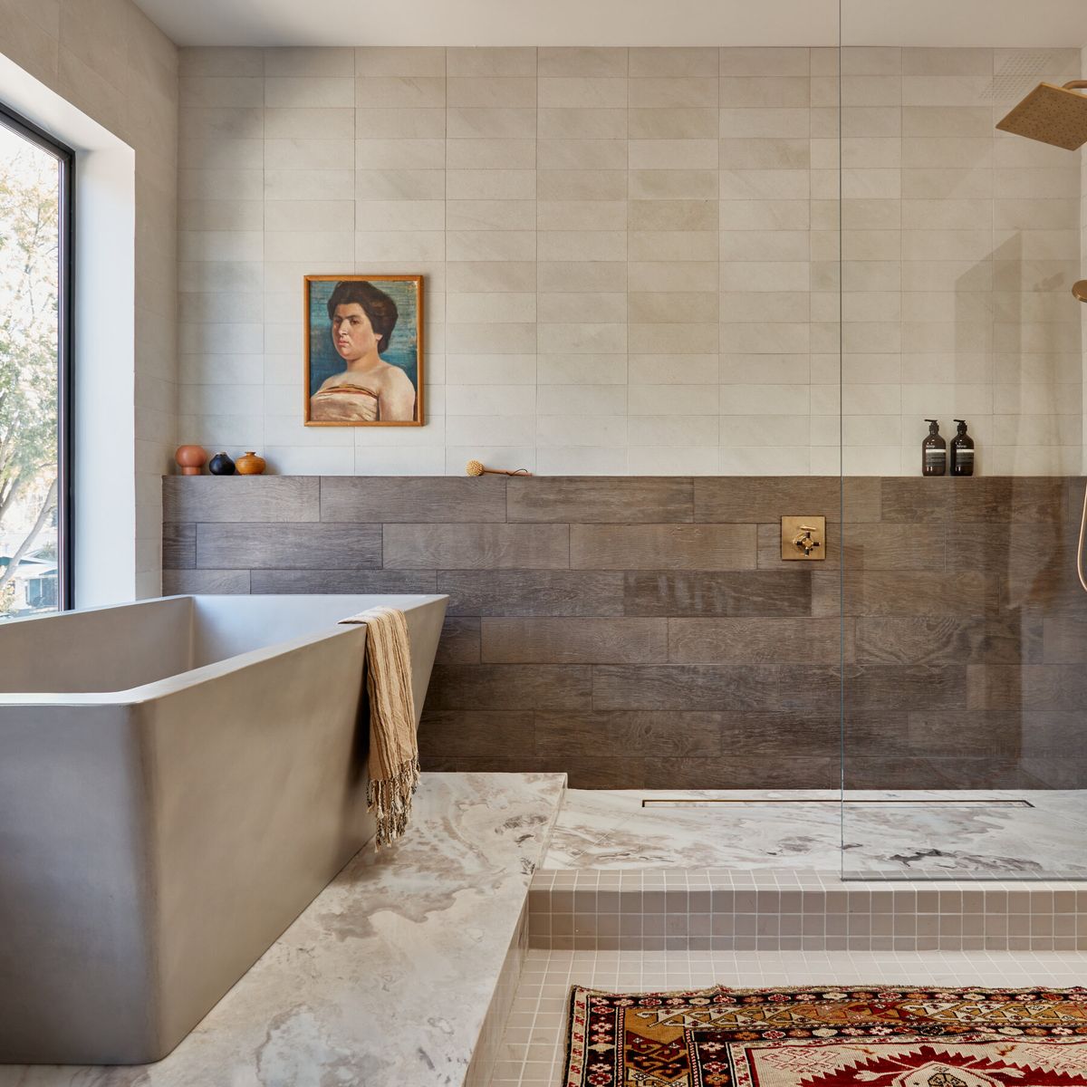 Bathroom remodel with a freestanding tub and warm wood vanity