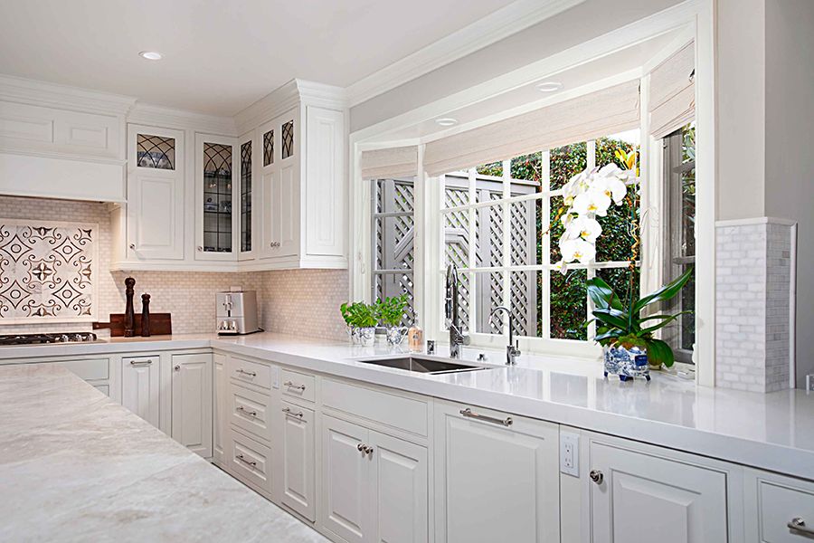 Custom kitchen with stained cabinetry and tile backsplash